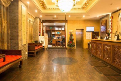 a lobby with a christmas tree in the middle of a building at James Joyce Coffetel Xian Dayanta Metro Station Branch in Xi'an