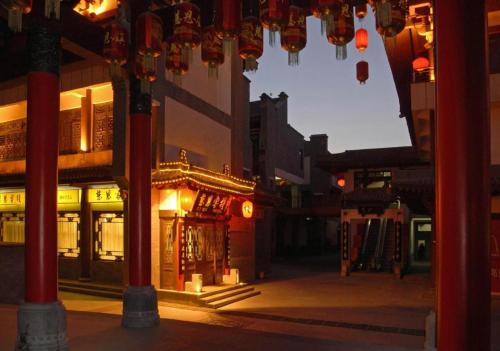 an empty street at night with chinese lights at James Joyce Coffetel Xian Dayanta Metro Station Branch in Xi'an