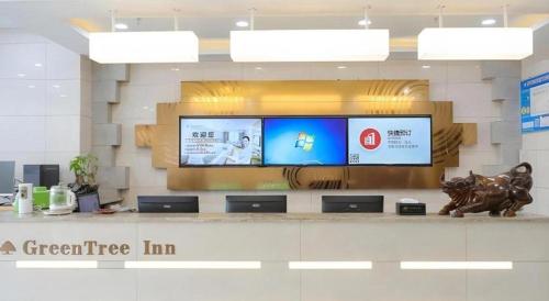 a store with a large television in a building at GreenTree Inn Jiaxin Puyuan Kaixuan Road in Jiaxing