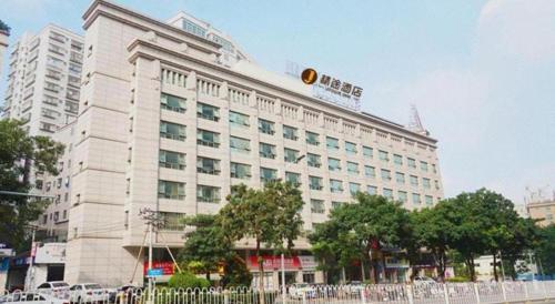 a large white building with a sign on top of it at Jingtu hotel zhanjiang dingsheng plaza store in Zhanjiang