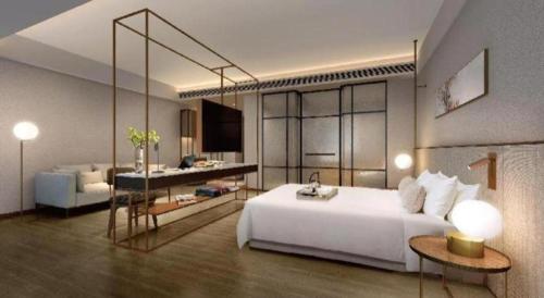 a bedroom with a large white bed and a living room at AURAYA BY SUNING NANJING XUZHUANG in Nanjing
