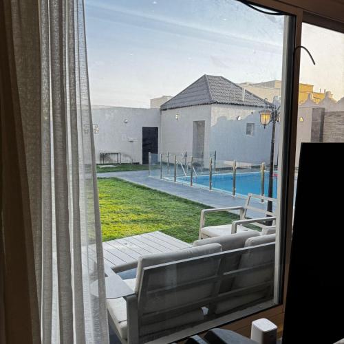 a view of a swimming pool from a window at Crystal Chalet Al-Aredh كريستال العارض in Riyadh