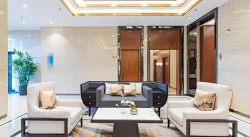 a living room with a couch and two chairs and a table at YUN-RAY Hotel Shijiazhuang in Shijiazhuang