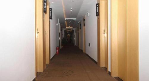 a hallway of an office building with a long corridor at GreenTree Inn Beijing Shunyi Fengbo Metro Station in Beijing