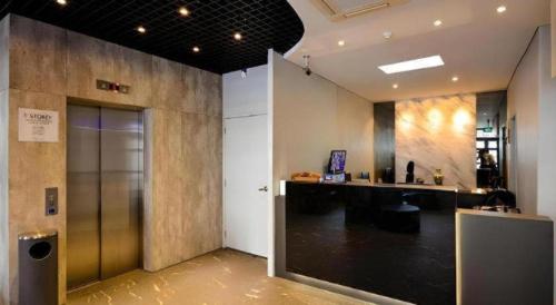 a room with a hallway with a counter and a door at The Keong Saik Hotel in Singapore
