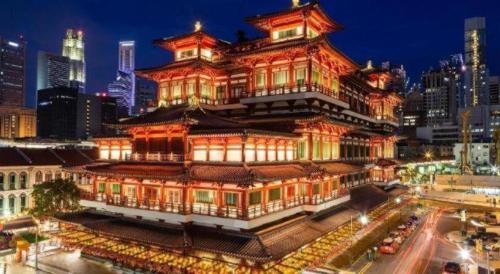 a large building with a tower in a city at The Keong Saik Hotel in Singapore