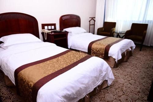 Postel nebo postele na pokoji v ubytování Heilongjiang Kunlun Hotel