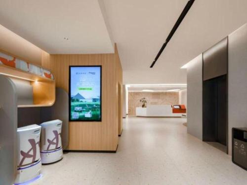 a hallway with a large screen in a building at Home Inns Plus Shanghai Xujiahui Branch in Shanghai