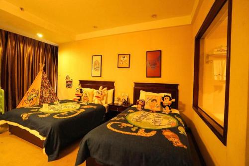 two beds in a hotel room with two at Datong Tiangui International Hotel in Datong