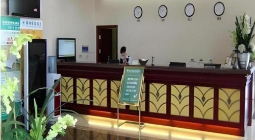 a bar with a sign in front of it at GreenTree Inn Tianjin Wuqing Distric Bohai Market in Tianjin