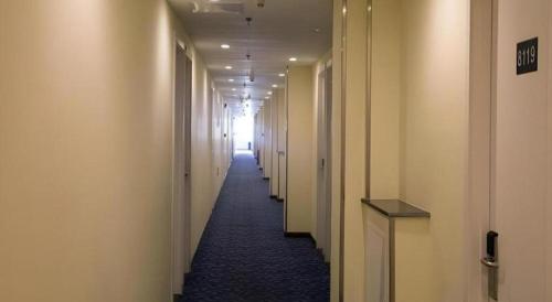 a hallway with white walls and a long hallway with white halls at 7 Days Inn Xi'an North Economic Development Zone 4th Fengcheng Road in Xi'an