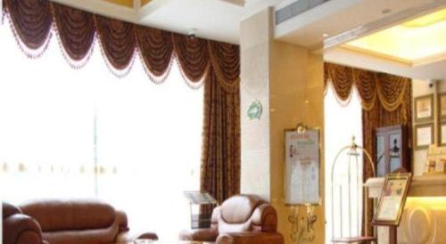 a living room with brown leather furniture and curtains at Shanghai Jinghang Hotel in Shanghai