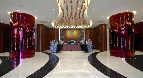 a lobby with a large room with a table in it at Harbin Ju Jian Hotel in Harbin