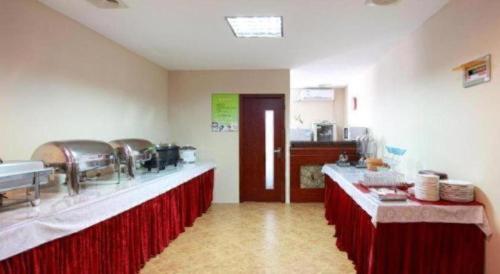 a kitchen with two long counters in a room at GreenTree Inn Hefei Chenghuangmiao San Xiao Kou Subway Station Hotel in Hefei
