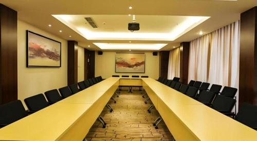 a long long table and chairs in a room at Jinjiang Metropolo Shanghai Minhang in Shanghai