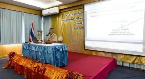 a man sitting at a table in front of a screen at Lake Inn Hotel in Songkhla