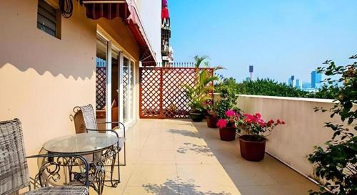 a patio with a table and chairs on a balcony at Zhongshan Louis Hotel in Zhongshan