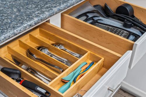 a wooden drawer with cutlery in a kitchen at Blue Havens in Rowlett