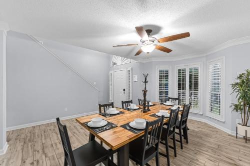 a dining room with a table and chairs and a ceiling fan at Blue Havens in Rowlett