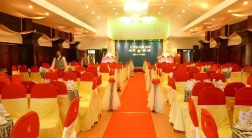a banquet hall with red and white tables and chairs at Can Gio Resort in Can Gio