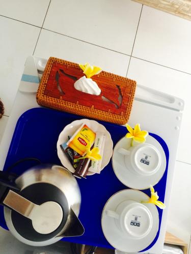 a blue tray with plates and a cake on it at Svaha Private Villas Ceningan in Nusa Lembongan