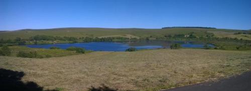 a view of a lake in the middle of a field at Beluga in La Godivelle