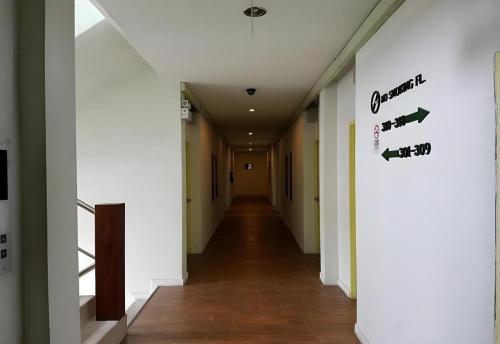 a hallway of an office building with a sign on the wall at Cactus Resort & Hotel in Khon Kaen