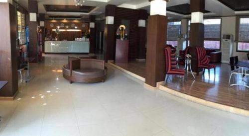 a lobby of a hotel with a bar and chairs at Cactus Resort & Hotel in Khon Kaen