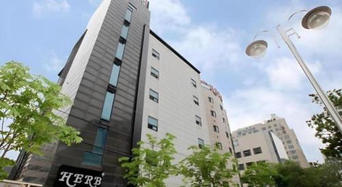 a tall building with a sign on the side of it at Hotel Casa Suwon in Suwon