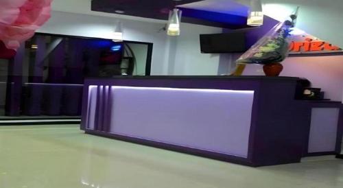 a purple and white counter in a room at Oriza Hotel Surabaya in Surabaya
