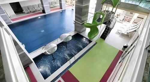 an empty gymnasium with a swimming pool with colorful floors at Midland Hotel in Phnom Penh