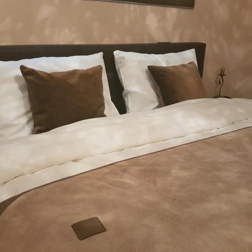 a large bed with white sheets and pillows at Classic Apartment in Braşov