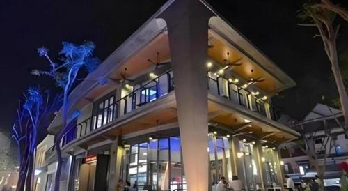 a large building at night with people sitting outside at Midland Hotel in Phnom Penh