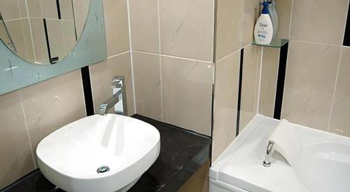 a bathroom with a white toilet and a sink at Benikea Ariul Hotel in Gunsan