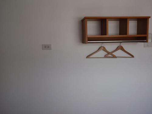 a shelf on a wall with a light on it at Iroom Hotel in Surat Thani