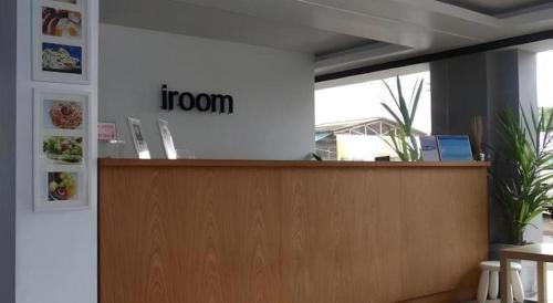 a reception desk with a sign that says iron at Iroom Hotel in Surat Thani