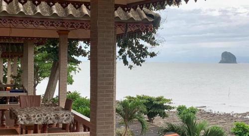 a view of the ocean from a house with a table at Wanghin Bungalow in Surat Thani