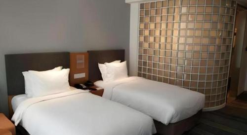 two beds sitting next to each other in a room at Holiday Inn Express Handan East By IHG in Handan