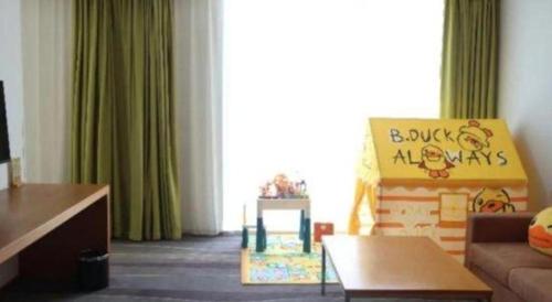 a living room with a couch and a large window at Holiday Inn Express Handan East By IHG in Handan
