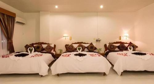 a bedroom with three beds in a room at Asia Hotel in Phnom Penh