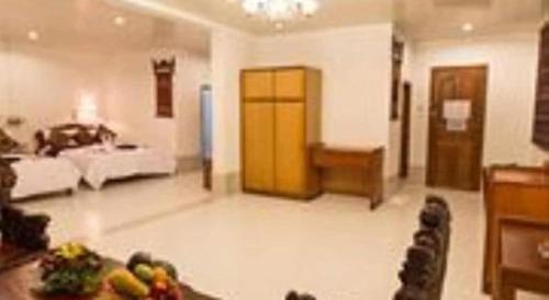 a living room with a couch and a table with fruits at Asia Hotel in Phnom Penh