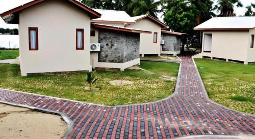 a brick walkway in front of a house at Naaval Hotel in Batticaloa