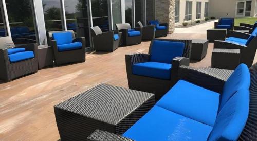 a group of chairs and tables in a building at Holiday Inn Express and Suites Hannibal-Medical Center By IHG in Hannibal