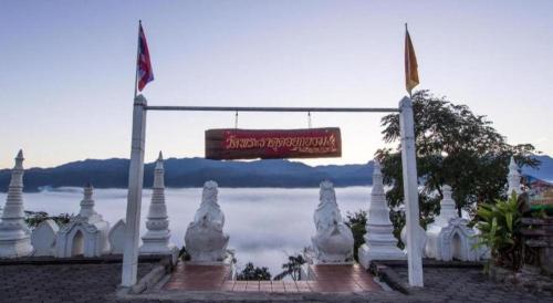 a sign for a temple with a view of the water at Panorama Hotel in Mae Hong Son