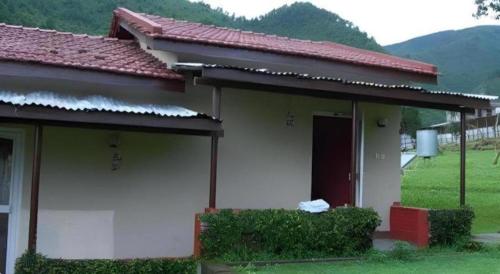 a white house with a red roof at New Dakshinkali Village Resort in Kathmandu