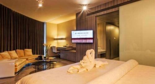 a hotel room with a bed and a tv at Jinjiang Metropolo Hotel - Qingdao Chengyang District Government in Qingdao