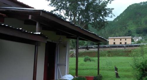 a house with a view of a field and a train at New Dakshinkali Village Resort in Kathmandu