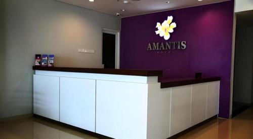 a cosmetics counter with a purple and white wall at Amantis Hotel in Demak