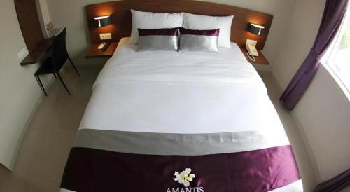 a bedroom with a large bed with at Amantis Hotel in Demak
