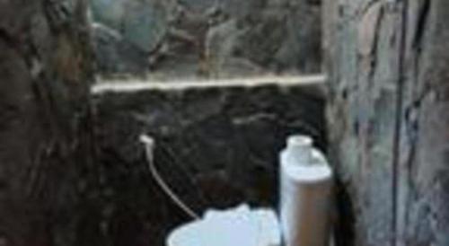 a dirty bathroom with a toilet with a window at VillaTel Salse in Bandung